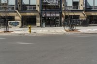 a building with a sign and a bike leaning against the side of it on a street