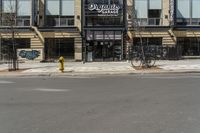 a building with a sign and a bike leaning against the side of it on a street