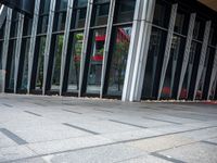 this is an image of a very long building that has many glass windows and a red rug on the outside