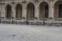 a man is walking on the street with a backpack and some poles and a bench