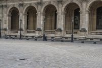 a man is walking on the street with a backpack and some poles and a bench