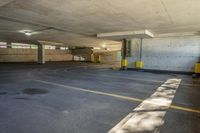 there is an empty parking garage with yellow caution tapes on the pavement and red signs