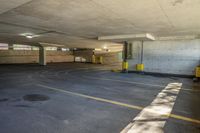 there is an empty parking garage with yellow caution tapes on the pavement and red signs