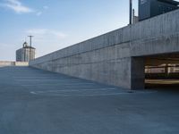 several large empty parking spaces in the city with buildings nearby in front of them -