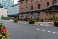 the potted planters in front of a building have flowers and plants in it