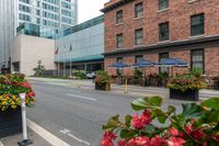 the potted planters in front of a building have flowers and plants in it