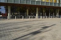 a modern building with lots of glass on the outside and inside of it, with a pedestrian pathway outside