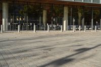 a modern building with lots of glass on the outside and inside of it, with a pedestrian pathway outside