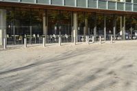 a modern building with lots of glass on the outside and inside of it, with a pedestrian pathway outside