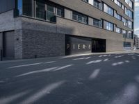 a parking garage under a building that says pier on it and a building with a bike on the sidewalk