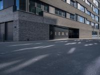 a parking garage under a building that says pier on it and a building with a bike on the sidewalk