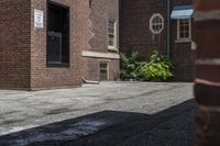 a white fire hydrant in between two buildings and a walkway with cement next to it