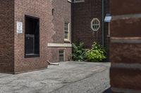 a white fire hydrant in between two buildings and a walkway with cement next to it