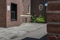 a white fire hydrant in between two buildings and a walkway with cement next to it