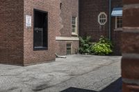 a white fire hydrant in between two buildings and a walkway with cement next to it