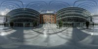 a round building in an outside area of a large city and it has a few stairs