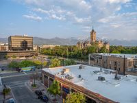 several large empty parking spaces in the city with buildings nearby in front of them -