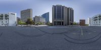 360 - shot image of several buildings in the middle of a deserted area with two streets, buildings, and a sign that says no parking