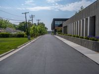 a building with a logo painted on the side near a street that has a sidewalk next to it