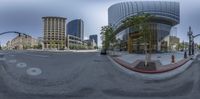 a street view with the intersection in the middle and buildings behind it at the corner