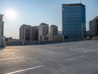 several large empty parking spaces in the city with buildings nearby in front of them -