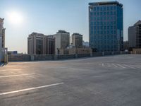 several large empty parking spaces in the city with buildings nearby in front of them -