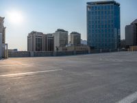 several large empty parking spaces in the city with buildings nearby in front of them -