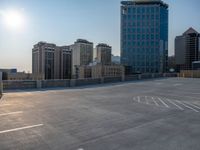 several large empty parking spaces in the city with buildings nearby in front of them -