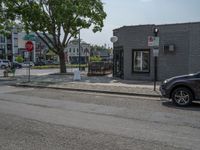 a store on the corner in a small town that has lots of gray brick walls