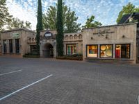 a very nice and fancy restaurant with some nice glass windows, and a brick driveway