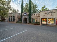 a very nice and fancy restaurant with some nice glass windows, and a brick driveway