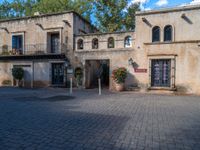 a large beige building with an open entry way leading to a restaurant and restaurant entrance