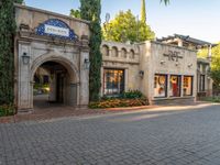 an entrance to the entrance and entry to a building with a blue tile roof and arched archway