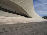 a person is skateboarding on some stone steps near the ocean wall on an overcast day