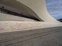 a person is skateboarding on some stone steps near the ocean wall on an overcast day