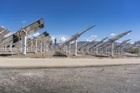 a row of solar panels on the ground of a solar park in the desert setting