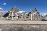 a row of solar panels on the ground of a solar park in the desert setting