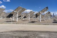 a row of solar panels on the ground of a solar park in the desert setting