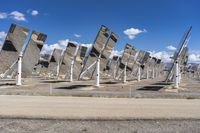 a row of solar panels on the ground of a solar park in the desert setting