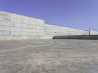 large concrete wall in a courtyard of a building with concrete walls and windows on the side of the wall