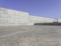 large concrete wall in a courtyard of a building with concrete walls and windows on the side of the wall