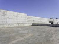 large concrete wall in a courtyard of a building with concrete walls and windows on the side of the wall