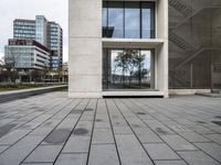 the stone pavement in front of the building has windows with no glass or steel bars