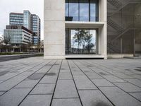 the stone pavement in front of the building has windows with no glass or steel bars