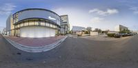 this is a 360 - lens photo showing a street scene and a building with a reflection