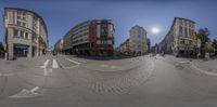 the view looking up at a city street from a fisheye lens, with the sun going through the clouds