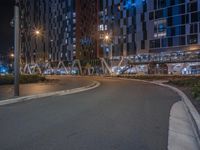 a car driving on a road in front of buildings at night with low visibility and long exposures