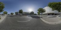 a curved road in front of an empty building on a clear day with a lens out