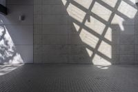 a brick floor that is on display in a room with large windows and floor tiles