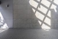 a brick floor that is on display in a room with large windows and floor tiles